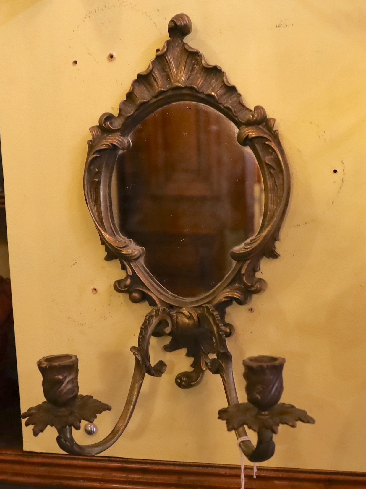 A pair of English Arts & Crafts brass candle sconces and a bronze girandole, height 18cm and 35cm